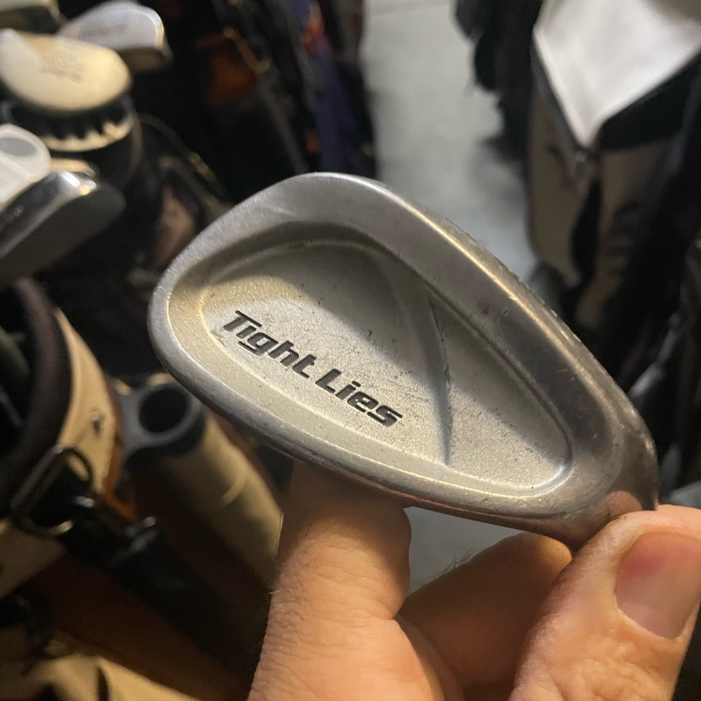 Adams tight lies pitching wedge in right hand
Steel